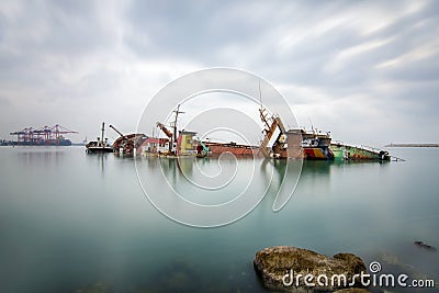 A sunken wreck rusting into the sea Stock Photo